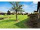 Waterfront backyard with lush grass and trees at 5648 Sunset Falls Dr, Apollo Beach, FL 33572