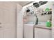 Well-equipped laundry room with washer, dryer, and ample storage shelves at 5648 Sunset Falls Dr, Apollo Beach, FL 33572