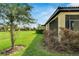 Landscaped backyard with screened porch at 5648 Sunset Falls Dr, Apollo Beach, FL 33572