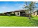 Spacious backyard with lush lawn and screened patio at 5648 Sunset Falls Dr, Apollo Beach, FL 33572