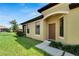 House exterior showcasing a front entrance with a brown door and side windows at 5648 Sunset Falls Dr, Apollo Beach, FL 33572