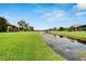 Community canal with lush landscaping and homes at 5648 Sunset Falls Dr, Apollo Beach, FL 33572