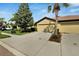 House exterior featuring a two-car garage and a neatly landscaped front yard at 5648 Sunset Falls Dr, Apollo Beach, FL 33572