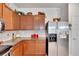 Modern kitchen with granite countertops and wood cabinets at 5648 Sunset Falls Dr, Apollo Beach, FL 33572