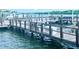 Wooden community dock with boat slips and calm water at 19111 Vista Bay Dr # 308, Indian Shores, FL 33785
