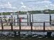 Wooden dock with boat slips on calm waters at 19111 Vista Bay Dr # 308, Indian Shores, FL 33785
