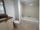 Bathroom with tub, toilet and granite vanity at 19111 Vista Bay Dr # 308, Indian Shores, FL 33785