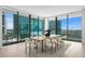 Modern dining room featuring a long wooden table and light-colored chairs at 1000 Water St # 1402, Tampa, FL 33602