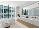 Modern bathroom with double vanity and large soaking tub at 1000 Water St # 1402, Tampa, FL 33602