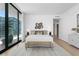 Light filled bedroom with a cozy sitting area and balcony access at 1000 Water St # 1402, Tampa, FL 33602