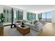 Bright living room with sectional sofa, large windows, and city views at 1000 Water St # 1402, Tampa, FL 33602