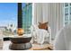 Relaxing sitting area with comfortable chair and city views at 1000 Water St # 1402, Tampa, FL 33602