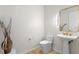 Powder room with pedestal sink and gold accents at 1000 Water St # 1402, Tampa, FL 33602