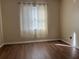 Bedroom with wood-look floors and window coverings at 13933 Reindeer Cir, Hudson, FL 34669