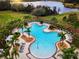 Community pool with lounge chairs and palm trees at 13933 Reindeer Cir, Hudson, FL 34669