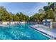 Inviting community pool with lounge chairs and umbrellas at 1473 Landings Cir # 44, Sarasota, FL 34231