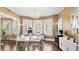 Elegant dining room featuring a chandelier, large windows, and hardwood floors at 532 Beach Ne Dr, St Petersburg, FL 33701
