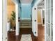 Well-lit hallway with hardwood floors and neutral decor, leads to the staircase at 532 Beach Ne Dr, St Petersburg, FL 33701