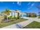Attractive single-story home with a blue garage door, lush landscaping, and a well-maintained lawn at 5502 Limelight Dr, Apollo Beach, FL 33572