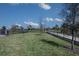 Community dog park with fenced-in area, grass, and waste disposal at 12395 Hearts Ease St, Venice, FL 34293