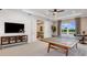 Fun game room with ping pong table and media area at 16285 Alpha Grove Pl, Odessa, FL 33556