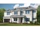 Two-story house with gray roof, white siding, and green shutters at 16285 Alpha Grove Pl, Odessa, FL 33556