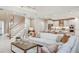 Open living room with white sectional sofa and large windows at 16285 Alpha Grove Pl, Odessa, FL 33556