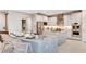Open kitchen with large island, white cabinets, and stainless steel appliances at 16285 Alpha Grove Pl, Odessa, FL 33556