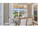Breakfast nook with wooden table, neutral decor and view to backyard at 16285 Alpha Grove Pl, Odessa, FL 33556