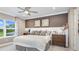 Comfortable bedroom with ceiling fan and large window at 16285 Alpha Grove Pl, Odessa, FL 33556