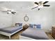 Bedroom with two beds, ceiling fan, and neutral decor at 1906 2Nd St, Indian Rocks Beach, FL 33785