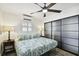 Bright bedroom with modern closet, stylish lamps, tropical bedding, and wood-look floors at 1906 2Nd St, Indian Rocks Beach, FL 33785