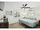 Airy bedroom with wood flooring, ceiling fan, tropical bedding, and natural light at 1906 2Nd St, Indian Rocks Beach, FL 33785