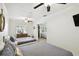 Bright bedroom featuring two beds, neutral coastal decor, ceiling fans, and an open doorway leading to the living area at 1906 2Nd St, Indian Rocks Beach, FL 33785