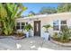 Attractive single Gathering home featuring manicured landscaping, a concrete driveway and covered porch at 1906 2Nd St, Indian Rocks Beach, FL 33785