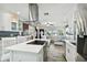 Open kitchen with stainless appliances, island cooktop, and views into the living room at 1906 2Nd St, Indian Rocks Beach, FL 33785