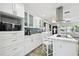 White kitchen features stainless appliances and views into the living room at 1906 2Nd St, Indian Rocks Beach, FL 33785