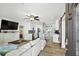 Open concept living room and kitchen featuring stainless steel appliances, breakfast bar and wood floors at 1906 2Nd St, Indian Rocks Beach, FL 33785