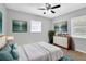 Bright bedroom with a ceiling fan, dresser, and large bed at 3202 E Elm St, Tampa, FL 33610