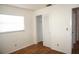 Bright bedroom with wood-look floors, a window, and a closet with sliding doors at 4254 96Th N Ter # Two, Pinellas Park, FL 33782