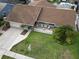 Aerial view of a well-maintained home with a landscaped front yard and a charming front porch with ample seating at 4608 Apple Ridge Ln, Tampa, FL 33624