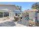 Outdoor back patio featuring a dining table, umbrellas, outdoor seating, and exterior access at 4608 Apple Ridge Ln, Tampa, FL 33624