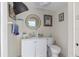 Cozy bathroom with a round mirror, white vanity, and coastal-themed decor for a relaxing space at 4608 Apple Ridge Ln, Tampa, FL 33624