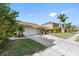 Exterior view of the home featuring a two-car garage, driveway and well-maintained landscaping at 4608 Apple Ridge Ln, Tampa, FL 33624