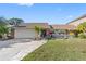 Two-car garage, attractive landscaping, inviting front porch at 4608 Apple Ridge Ln, Tampa, FL 33624