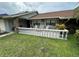 Inviting front porch featuring stone accents, comfortable seating, and a well-maintained lawn at 4608 Apple Ridge Ln, Tampa, FL 33624