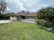 Inviting home featuring a manicured front lawn, attractive landscaping, a stone accent wall, and a welcoming front porch at 4608 Apple Ridge Ln, Tampa, FL 33624