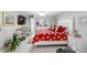 Bright main bedroom features tile flooring, TV, vibrant decor, plus a bed with storage bench at 4608 Apple Ridge Ln, Tampa, FL 33624