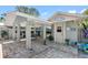 Outdoor kitchen and seating area with a covered patio, tile flooring, and bar seating at 4608 Apple Ridge Ln, Tampa, FL 33624