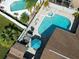 Aerial view of backyard featuring swimming pool and spa, outdoor seating and lush landscaping at 4608 Apple Ridge Ln, Tampa, FL 33624